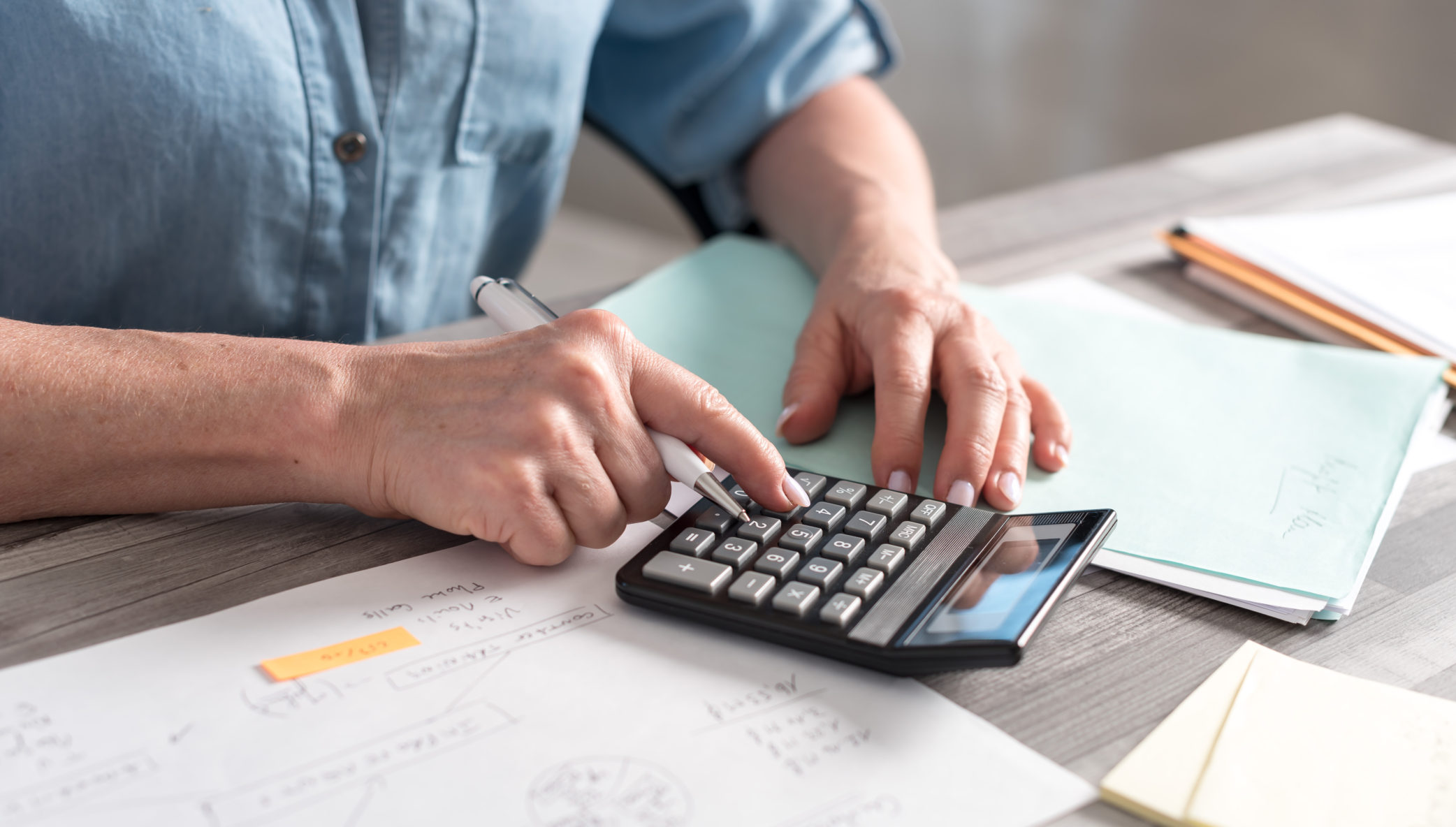 Business owner calculating overhead costs