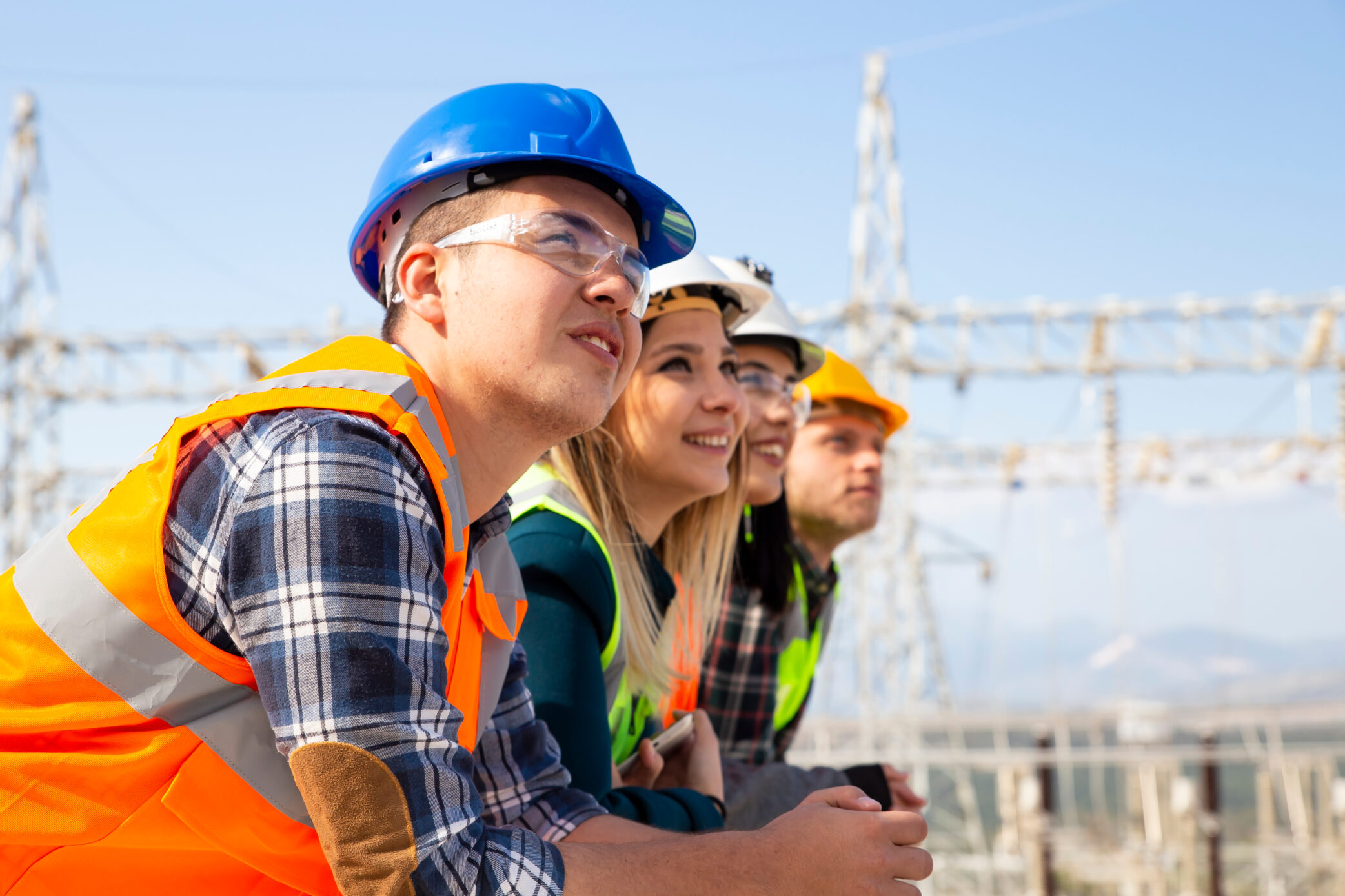 Four young people working as roofers