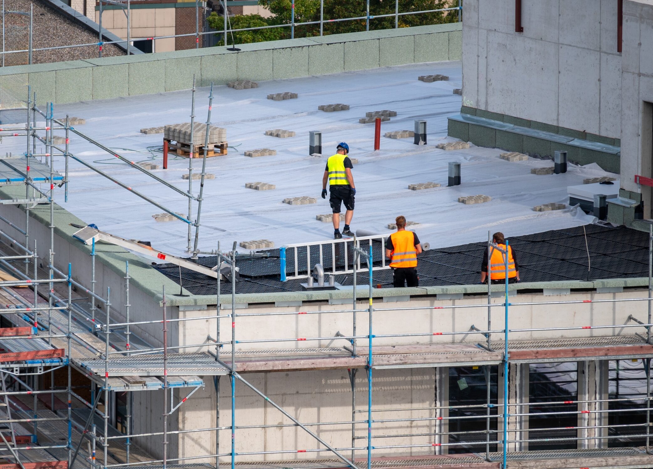 Commercial roofers installing a warehouse roof